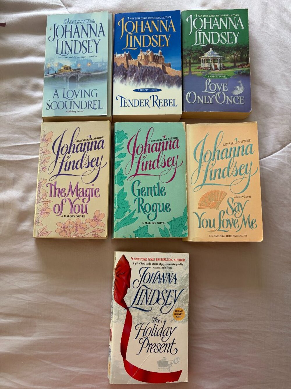 Lot of 7, Johanna Lindsey Paperbacks. (6 Mallory Stories and 1 Hoilday Story.)